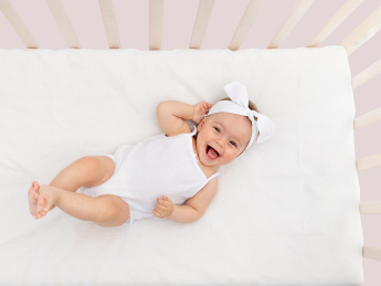 Newborn sleeping hotsell in cot